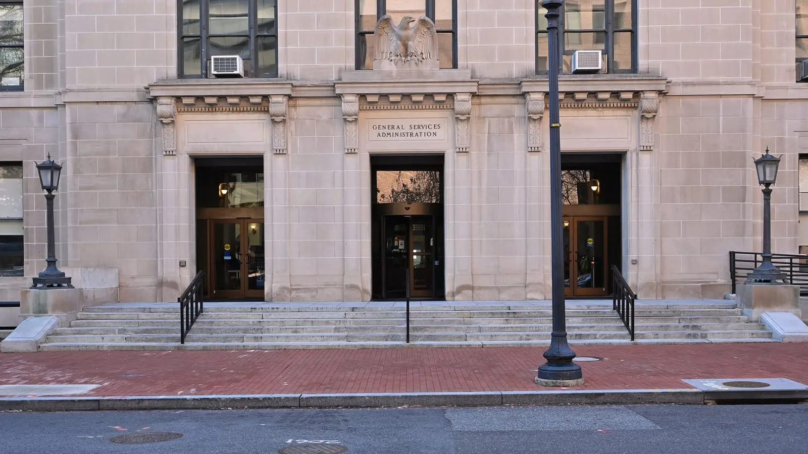 The stone main entrance of the General Services Administration headquarters at 1800 F Street NW in Washington, DC, with a carved eagle above the doors.