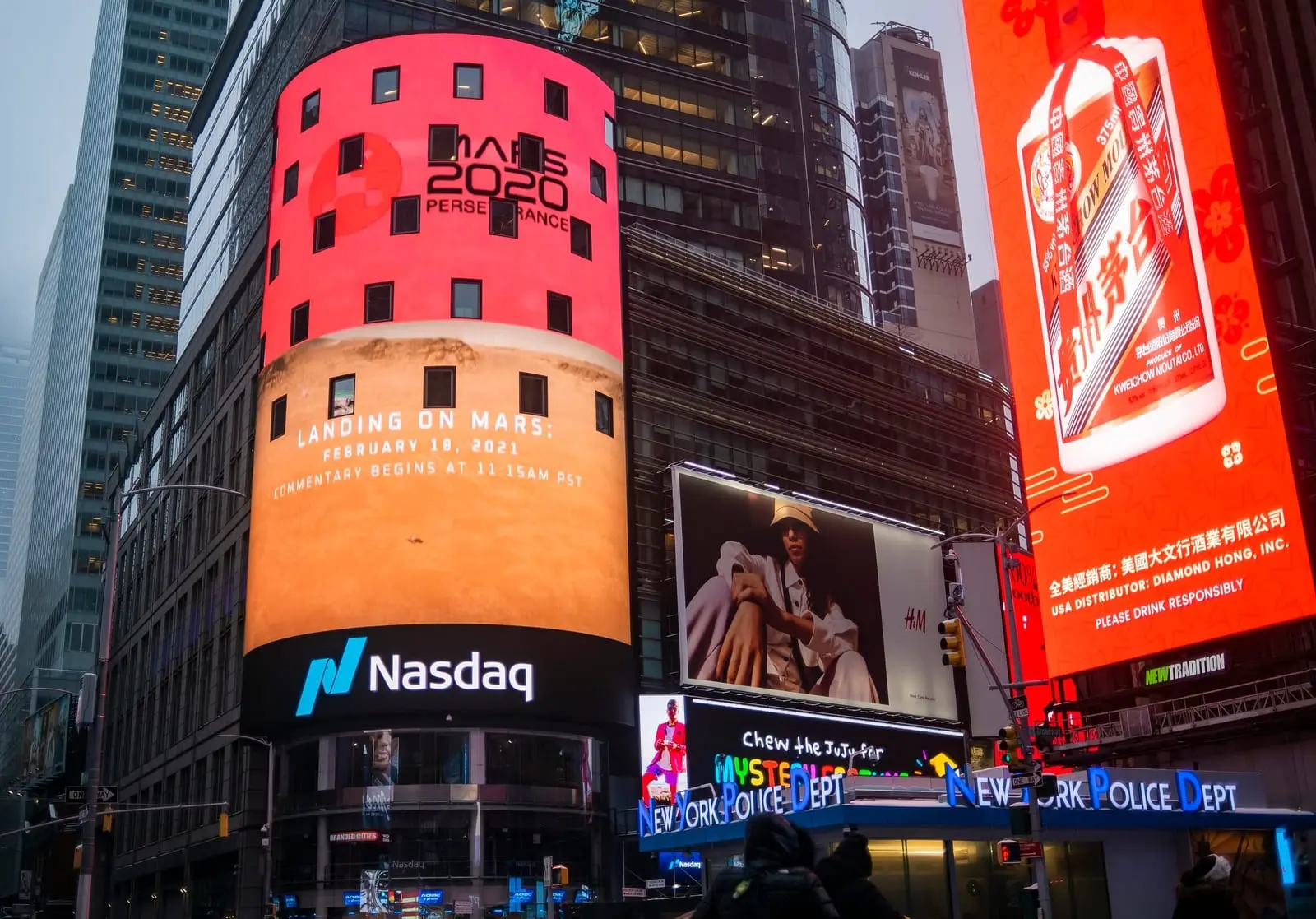 The curved Nasdaq MarketSite video board in Times Square, New York, showing a Mars 2020 Perseverance message above a large Nasdaq sign.